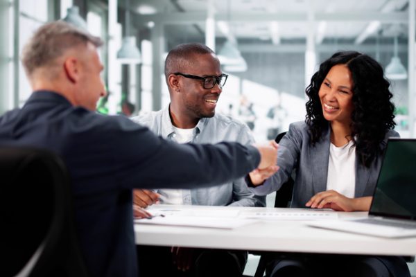 Successful real estate agent Advisor Assists Happy Couple In Looking At Diverse Estate.